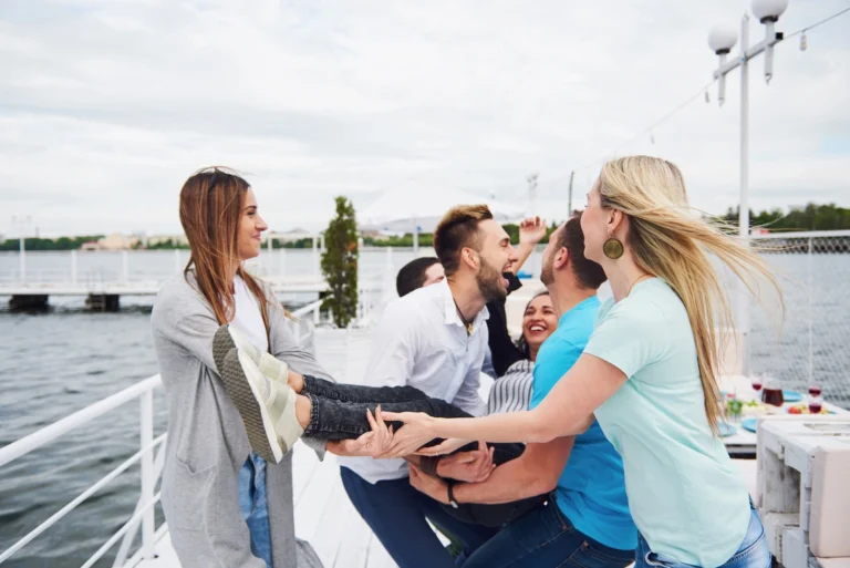 group-happy-friends-beach-man-tossing-happy-woman_